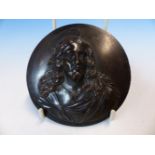 A BRONZE ROUNDEL CAST WITH THE HEAD AND SHOULDERS OF CHRIST IN RELIEF. Dia. 10cms.