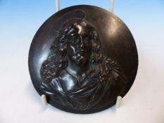 A BRONZE ROUNDEL CAST WITH THE HEAD AND SHOULDERS OF CHRIST IN RELIEF. Dia. 10cms.