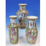 THREE CANTON VASES PAINTED WITH ALTERNATING FIGURE AND GARDEN RESERVES, TWO WITH GILT MASK AND