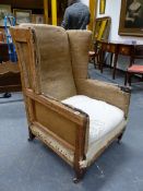 A WING ARMCHAIR ON TAPERING SQUARE MAHOGANY FRONT LEGS WITH CASTER FEET