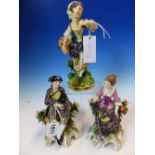 A PAIR OF GERMAN FIGURES OF SEATED GRAPE HARVESTERS. H 17cms. TOGETHER WITH A CROWN DERBY FIGURE