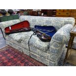 A VICTORIAN THREE SEAT SETTEE UPHOLSTERED IN CREAM PRINTED IN GREY WITH CLASSICAL SUBJECTS, CERAMIC