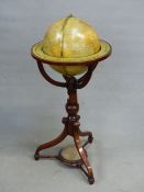A TERRESTIAL GLOBE LABELLED MERZBACH AND FALK 1881 IN A MAHOGANY STAND WITH A COMPASS MOUNTED