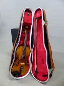 A GUARNERIUS LABELLED VIOLIN TOGETHER WITH A PAESOLD BOW IN LEATHERETTE CASE WITH CANVAS OUTER