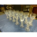A SET OF TWELVE WINE GLASSES, EACH CONICAL BOWL ON A STEM WITH HOLLOW BALL CENTRAL TO DISC KNOPS,