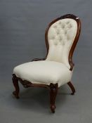 A 19th C. WALNUT SHOW FRAME SIDE CHAIR THE BUTTONED BACK BELOW A CARVED CABOCHON FLANKED BY FOLIAGE,