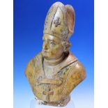 AN 18th/19th C. LIMEWOOD BUST OF A BISHOP, HIS COPE AND MITRE WITH TRACES OF GREEN DECORATION, HIS