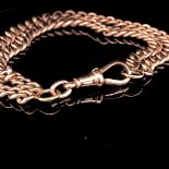 9ct ROSE GOLD DOUBLE GRADUATED SOLID CURB BRACELET COMPLETE WITH DOG TOOTH SWIVEL CLASP. WEIGHT
