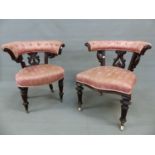TWO SIMILAR MAHOGANY VICTORIAN DESK ARMCHAIRS, THE HOOP TOP RAILS BUTTON UPHOLSTERED OVER FOLIATE