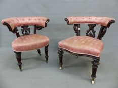 TWO SIMILAR MAHOGANY VICTORIAN DESK ARMCHAIRS, THE HOOP TOP RAILS BUTTON UPHOLSTERED OVER FOLIATE