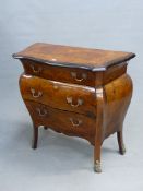 AN ITALIAN MARQUETRY WALNUT THREE BOMBE DRAWER CHEST, THE SERPENTINE FRONTED TOP WITH EBONISED EDGE