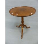 A GEORGE III MAHOGANY WINE TABLE, THE DISHED CIRCULAR TOP TILTING ON A BALUSTER COLUMN WITH TRIPOD
