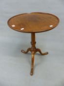 A GEORGE III MAHOGANY WINE TABLE, THE DISHED CIRCULAR TOP TILTING ON A BALUSTER COLUMN WITH TRIPOD