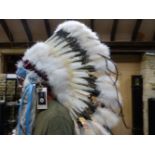 AN OKLAHOMA INDIAN CRAFTS Co. REPLICA WAR BONNET WORKED IN BEADS, FEATHERS AND FUR