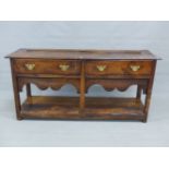 A 19th C. OAK DRESSER, THE RECTANGULAR TOP OVER TWO DRAWERS AND OPEN POT BOARD BETWEEN THE STILE