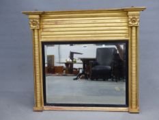 A 19th C. RECTANGULAR MIRROR WITHIN REEDED EBONY SLIP FLANKED BY GILT FLOWER HEAD TOPPED RING TURNED