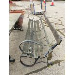 A PAIR OF GARDEN BENCHES WITH WROUGHT IRON ENDS.