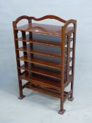 AN ARTS AND CRAFTS STYLE MAHOGANY MUSIC SHELF IN THE MANNER OF SHOOLBRED. 56cm x 31cm x 93cm (H).