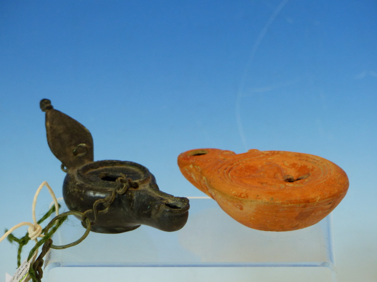 A ROMAN BRONZE OIL LAMP WITH HANGING CHAIN AND LEAF SHAPED HANDLE. W 11.5cms. TOGETHER WITH A