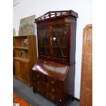 A LATE GEORGIAN MAHOGANY BUREAU BOOKCASE WITH PIERCED CORNICE OVER GLAZED DOORS, THE FALL WITH