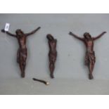 THREE MAHOGANY STAINED PINE FIGURES OF CHRIST CRUCIFIED. H 50cms.