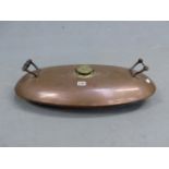 AN ANTIQUE LARGE TWO HANDLED COPPER HOT WATER BOTTLE, LABELLED WITH INSTRUCTION PLAQUE. W. 62cms.
