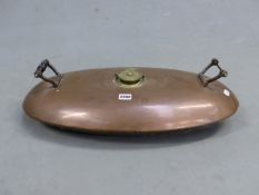 AN ANTIQUE LARGE TWO HANDLED COPPER HOT WATER BOTTLE, LABELLED WITH INSTRUCTION PLAQUE. W. 62cms.