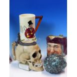 A GERMAN PORCELAIN SKULL TANKARD, A DOULTON SIMON CELLARER MASK JUG, A CHILDS CERAMIC HEAD, A