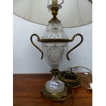 TWO SIMILAR BRASS MOUNTED CUT GLASS TWO HANDLED URN SHAPED TABLE LAMPS ON SQUARE FEET. H 40cms.