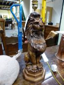 A TABLE LAMP WITH RED SHADE, THE BASE AS A LION SEATED ON A STEPPED OCTAGONAL BASE.