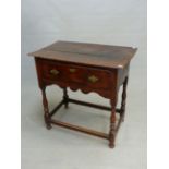 AN 18th C. OAK SIDE TABLE, THE TWO PLANK TOP OVER A DRAWER, THE WAVY APRON AND BALUSTER TURNED