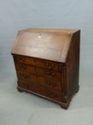 A GEORGE III OAK BUREAU, THE FALL AND FOUR GRADED DRAWERS WITH MAHOGANY BANDING ABOVE BRACKET