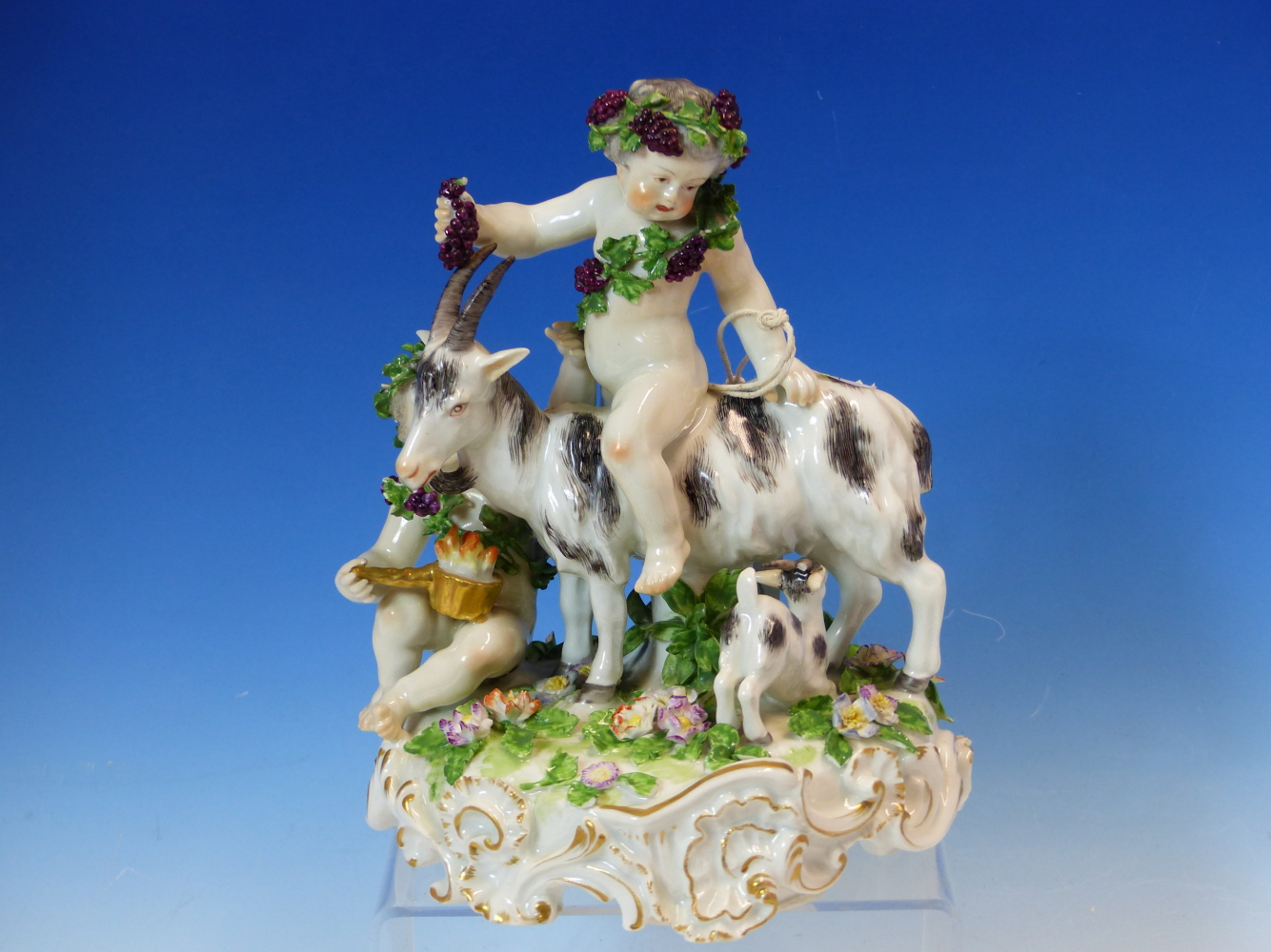 A CONTINENTAL GROUP OF BACCHIC PUTTI, ONE DRAPED IN GRAPES RIDES A GOAT WHICH SUCKLES HER KID. H