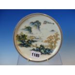 A CHINESE DISH PAINTED WITH A FIGURE CROSSING A BRIDGE BETWEEN MOUNTAINOUS ISLANDS, TWO CHARACTER