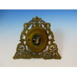 A VICTORIAN EASEL BACKED PIERCED FOLIATE GILT METAL MINIATURE FRAME, THE OVAL DOOR INSET WITH PIETRA