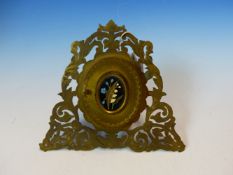 A VICTORIAN EASEL BACKED PIERCED FOLIATE GILT METAL MINIATURE FRAME, THE OVAL DOOR INSET WITH PIETRA