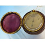 A LEATHER CASED WEST POCKET BAROMETER, THE TOP ARC OF THE SILVERED DIAL WITH BAROMETRIC READING