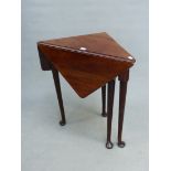 AN 18th C. AND LATER MAHOGANY FLAP TOP TRIANGULAR TABLE ON CYLINDRICAL LEGS TAPERING TO PAD FEET,