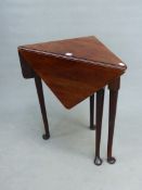 AN 18th C. AND LATER MAHOGANY FLAP TOP TRIANGULAR TABLE ON CYLINDRICAL LEGS TAPERING TO PAD FEET,