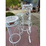 A PAIR OF WROUGHT IRON PATIO CHAIRS, THREE PLANT STANDS AND A LOVE SEAT (6).