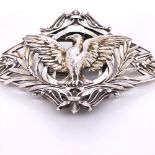 A CONTINENTAL SILVER BELT BUCKLE WITH A HINGED NICKEL CLASP. CHASED AND ENGRAVED WITH A SPREAD