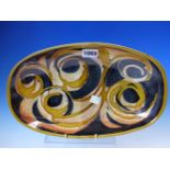 A WOOLMILL POTTERY ROUNDED RECTANGULAR BOWL WITH OCHRE SCROLLS ON A BLACK GROUND. W 32cms.