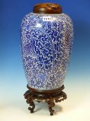 A CHINESE BLUE AND WHITE OVOID JAR, WOOD COVER AND STAND, PAINTED WITH THREE PHOENIX AMONGST