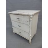 A 19th C. PAINTED PINE CHEST OF THREE DRAWERS BELOW A SERPENTINE FRONTED TOP AND ON FOLIATE CARVED