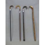 FOUR HORN HANDLED WALKING STICKS, ONE WITH HALLMARKED SILVER BAND, THE LAST CARVED WITH RELIGIOUS