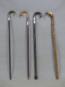 FOUR HORN HANDLED WALKING STICKS, ONE WITH HALLMARKED SILVER BAND, THE LAST CARVED WITH RELIGIOUS