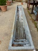 A LONG GALVANISED TROUGH.