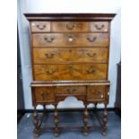 AN 18th.C. AND LATER WALNUT CHEST ON STAND OF THREE SHORT AND THREE LONG GRADUATED DRAWERS OVER A