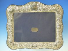A HALLMARKED SILVER EMBOSSED PHOTOGRAPH FRAME WITH BLUE VELVET BACK, DATED 1996 SHEFFIELD, FOR