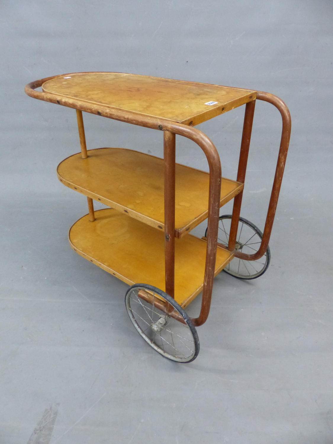 A THREE TIER TWO WHEEL TROLLEY WITH BENTWOOD SUPPORTS. W 88 x D 41 x H 77cms.